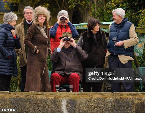 Spectators watch the 159th Boat Race on the River Thames, London.