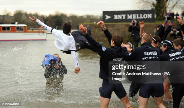 The Oxford University's cox Oskar Zorrilla is thrown into the Thames by his team mates as they celebrate winning the 159th Boat Race on the River...