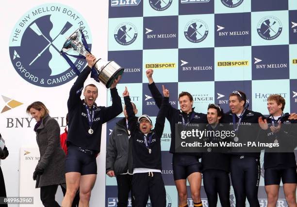 Oxford's president Alex Davidson celebrate winning the 159th Boat Race on the River Thames at Mortlake Boat Club, London.