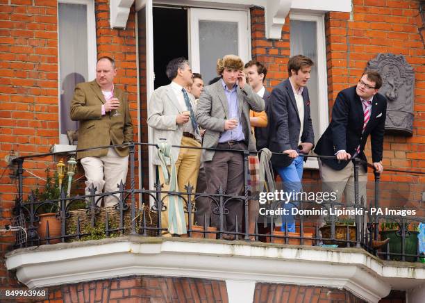 Spectators watch the 159th Boat Race on the River Thames, London.