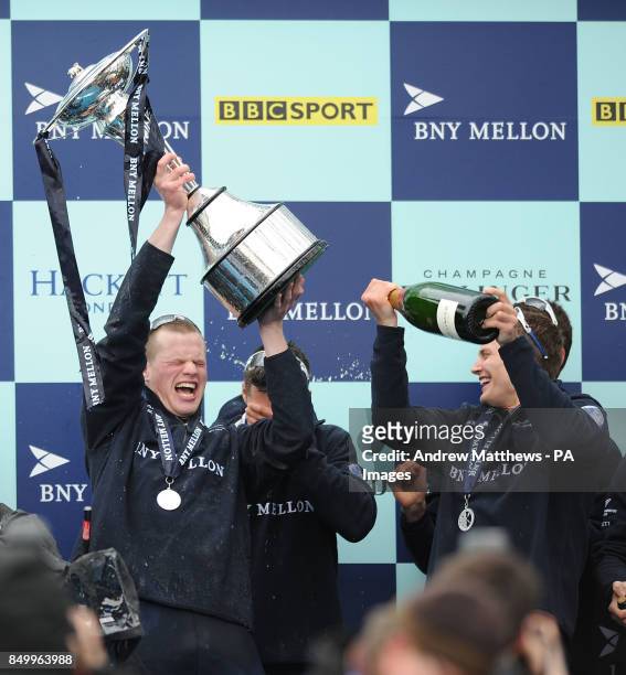 Oxford University Eight's Geordie Macleod celebrates with the trophy after his boat wins the 159th Boat Race on the River Thames, London.