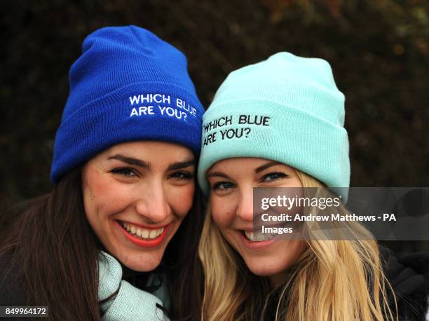 Oxford University and Cambridge University hats with the slogan 'Which Blue Are You?' are modelled by two ladies before the 159th Boat Race on the...