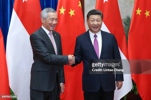 Singapore Prime Minister, Lee Hsien Loong shakes hands with Chinese President Xi Jinping before during a meeting at The Great Hall Of The People on...