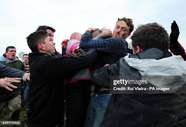 Villagers participate in the traditional game of bottle kicking at Hallaton, Leicestershire.