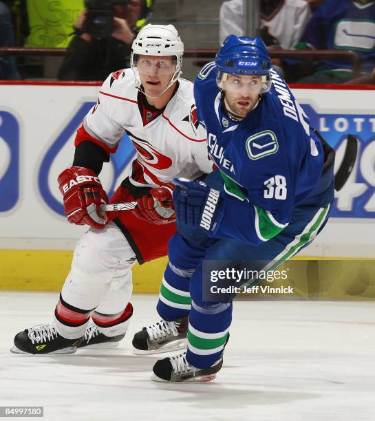 Joni Pitkanen of the Carolina Hurricanes and Pavol Demitra of the Vancouver Canucks skate up ice during their game at General Motors Place on...