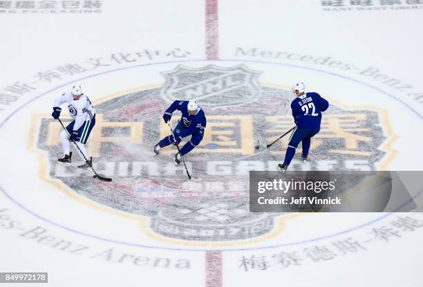 Patrick Wiercioch, Alexander Edler and Daniel Sedin of the Vancouver Canucks skate a drill during their practice at Mercedes-Benz Arena September 20,...