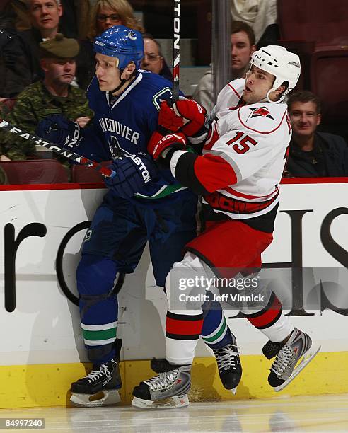 Tuomo Ruutu of the Carolina Hurricanes checks Sami Salo of the Vancouver Canucks during their game at General Motors Place on February 3, 2009 in...