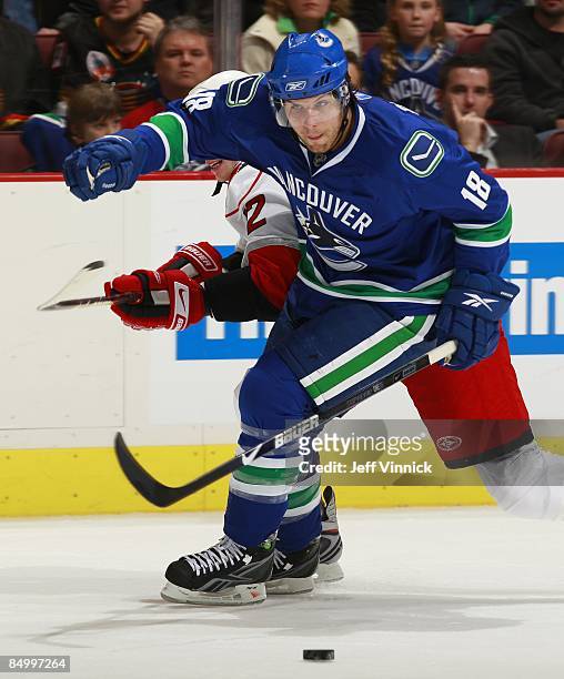 Steve Bernier of the Vancouver Canucks skates up ice with the puck during their game against the Carolina Hurricanes at General Motors Place on...