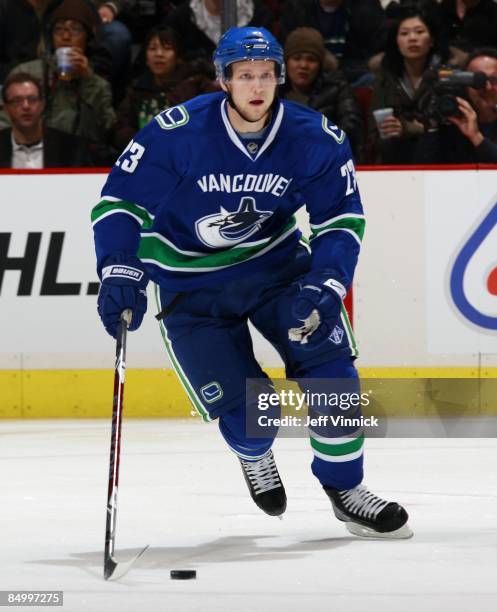 Alexander Edler of the Vancouver Canucks skates up ice with the puck during their game against the Carolina Hurricanes at General Motors Place on...