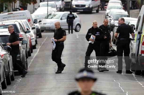 Police leave a vehicle to enter a property on West Street on September 20, 2017 in Newport, Wales. A 48-year-old man and a 30-year-old man have been...