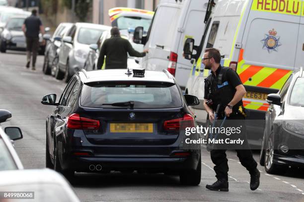 Police officer carries bolt cutters into a property on West Street on September 20, 2017 in Newport, Wales. A 48-year-old man and a 30-year-old man...