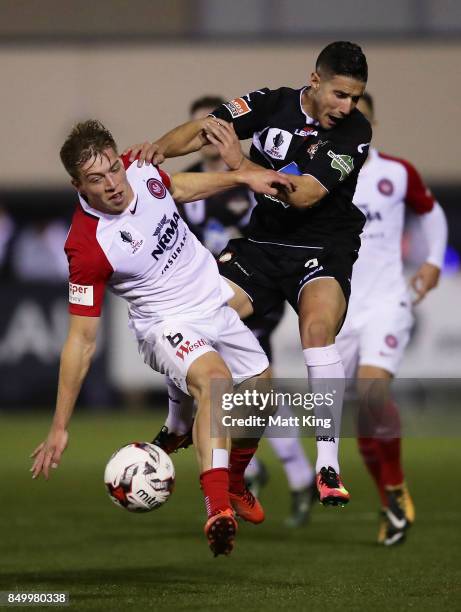 Jacob Melling of the Wanderers competes for the ball against Giorgio Speranza of Blacktown City during the FFA Cup Quarterfinal match between...