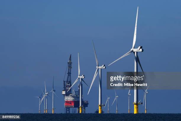 Some of the 116 giant turbines are seen off the coast of Sussex on September 20, 2017 in Brighton, England. The last of 116 wind turbines have been...