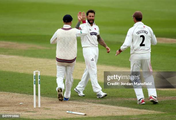 Peter Trego of Somerset celebrates with his teammates after dismissing Rory Burns of Surrey during day two of the Specsavers County Championship...