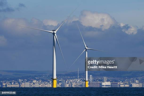Two of the 140m turbines dominate the skyline off the coast of Brighton on September 20, 2017 in Brighton, England. The last of 116 wind turbines...