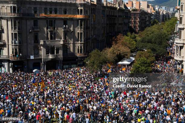 People demonstrate outside the Catalan Vice-President and Economy office as police officers holds a searching operation inside on September 20, 2017...