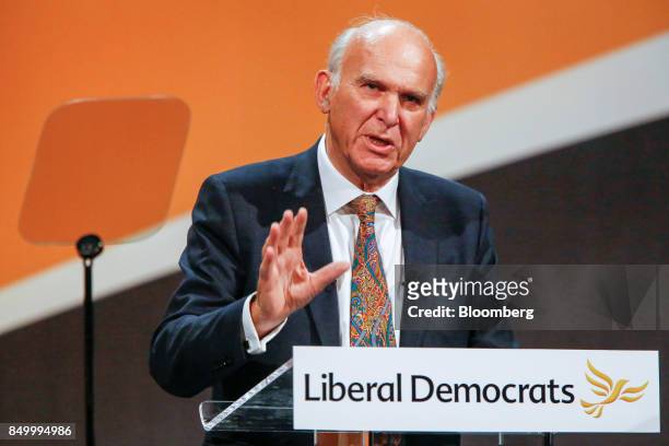 Vince Cable, leader of the U.K.'s Liberal Democrat Party, gestures as delivers his keynote speech at the party's annual conference in Bournemouth,...