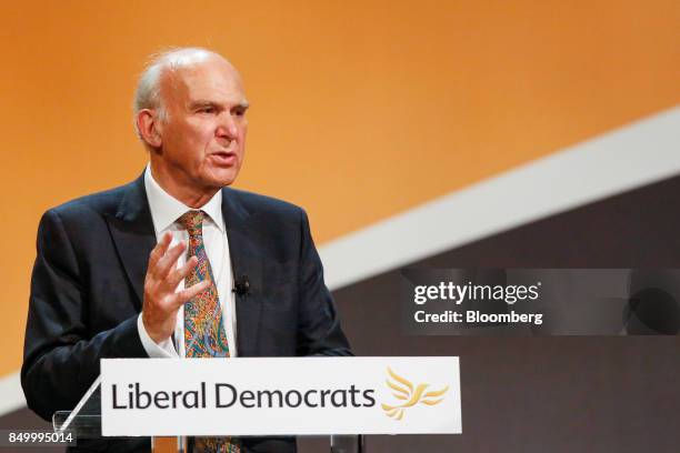 Vince Cable, leader of the U.K.'s Liberal Democrat Party, gestures as he delivers his keynote speech at the party's annual conference in Bournemouth,...