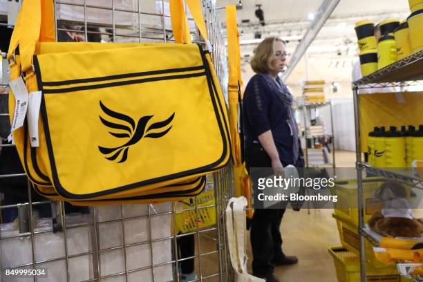 An attendee views U.K.'s Liberal Democrat Party branded merchandise on sale at the party's annual conference in Bournemouth, U.K., on Tuesday, Sept....