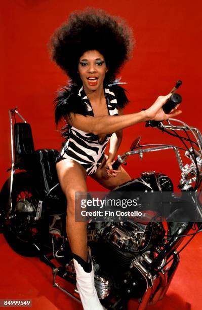 Photo of Betty DAVIS; Posed studio portrait of Betty Davis, on motorbike