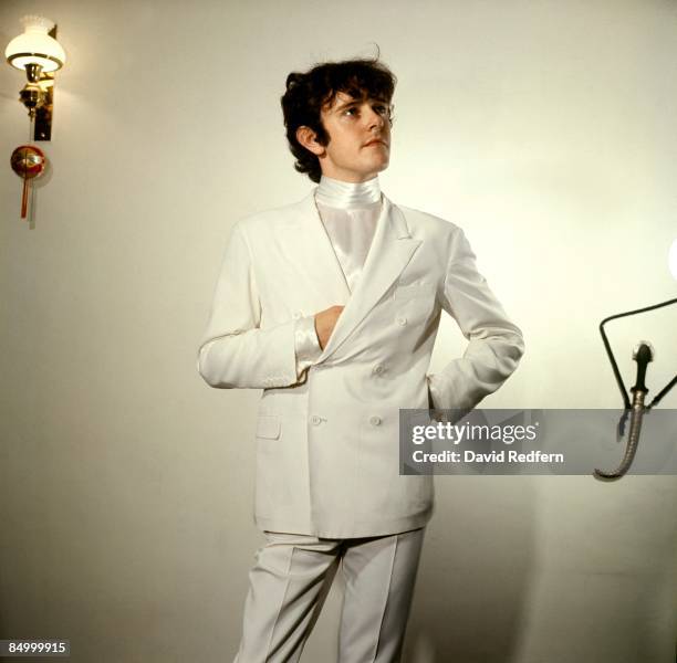 Scottish singer and musician Donovan poses in white double breasted suit and satin shirt for a portrait session circa 1967. Image is part of David...