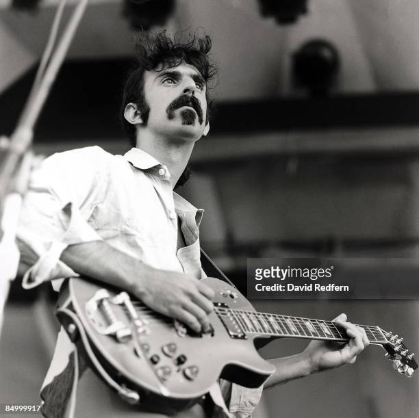American musician and guitarist Frank Zappa performs live on stage, playing a Gibson Les Paul guitar with Bigsby vibrato, with The Mothers of...