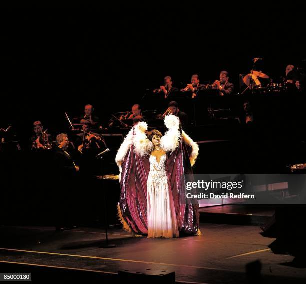 Welsh singer Shirley Bassey performs live on stage in Bristol, England in 1996.