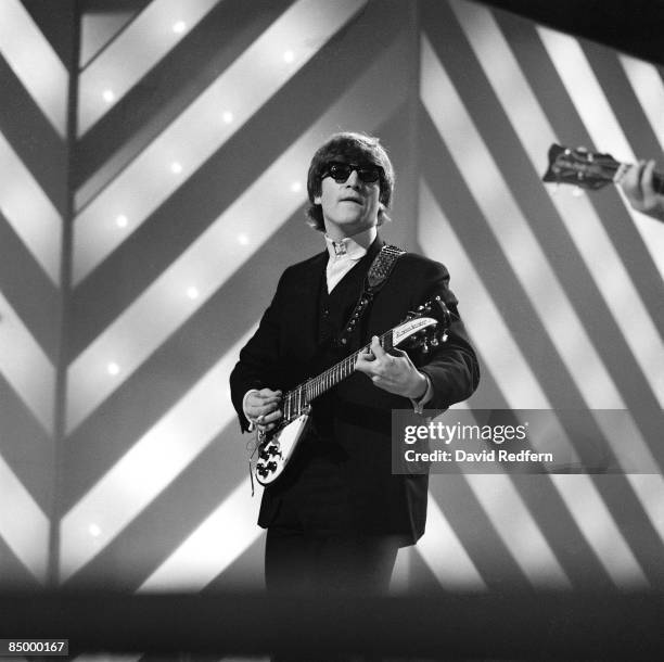 John Lennon of English rock and pop group The Beatles plays his second Rickenbacker 325 guitar on stage during rehearsals for the ABC Television...