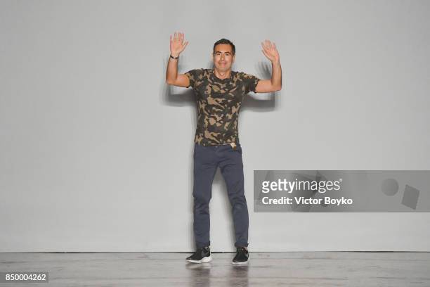 Designer Cristiano Burani acknowledges the applause of the audience after his show during Milan Fashion Week Spring/Summer 2018 on September 20, 2017...