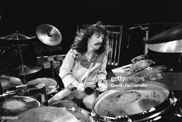 Photo of Neil PEART and RUSH, Neil Peart performing live onstage, playing drums at the Odeon on A Farewell To Kings Tour