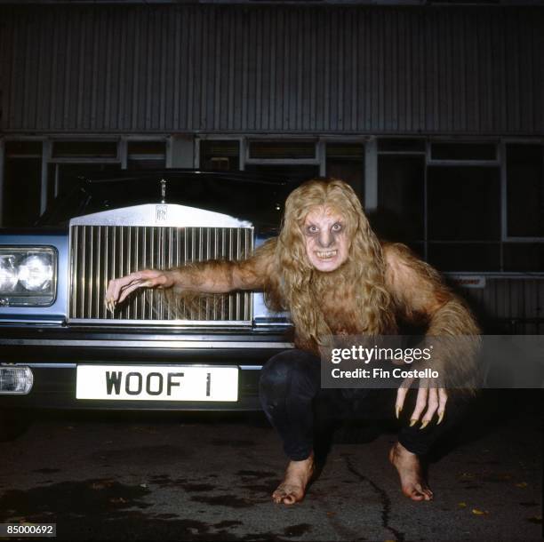 Photo of Ozzy OSBOURNE; posed, studio, made up as werewolf, crouching by Rolls Royce car, during 'Bark At The Moon' album cover shoot