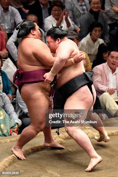 Ozeki Goeido pushes sekiwake Mitakeumi out of the ring to win during day eleven of the Grand Sumo Autumn Tournament at Ryogoku Kokugikan on September...