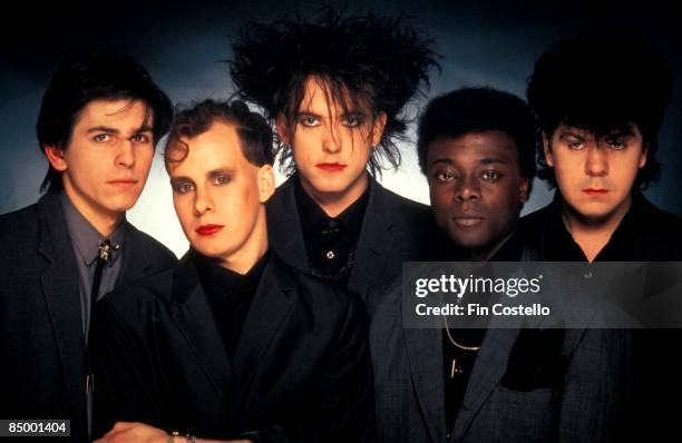 The Cure, posed, studio, group shot, circa 1984. L-R: Phil Thornalley, Porl Thompson, Robert Smith, Andy Anderson , Lol Tolhurst.