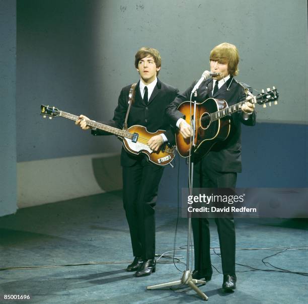 From left, Paul McCartney and John Lennon of English rock and pop group The Beatles perform on stage for the American Broadcasting Company music...