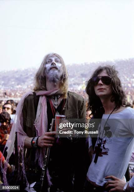 From left, saxophonist Nik Turner and keyboard player Tim Blake of English rock group Hawkwind in the audience on the first day of the 1970 Isle of...