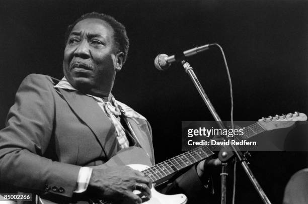 American blues singer and guitarist Muddy Waters performs live on stage playing a Fender Telecaster guitar at the New Victoria Theatre as part of the...