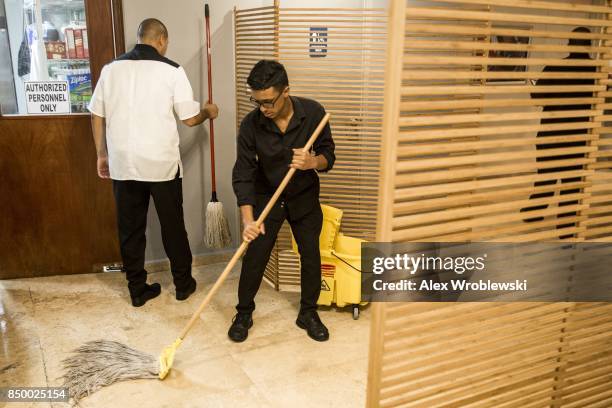 Employees of the Ciqala hotel clean the dining room as Hurricane Maria bears down on Puerto Rico on September 20, 2017 in San Juan. Thousands of...