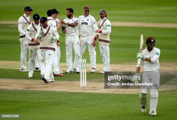 Peter Trego of Somerset celebrates with his teammates after dismissing Ben Foakes of Surrey during day two of the Specsavers County Championship...