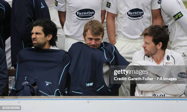 Sussex's Amjad Khan with Chris Nash and Ed Joyce try to keep warm in freezing conditions during the team photocall at the Brightonandhovejobs.com...