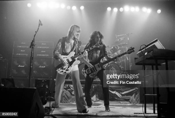 Photo of RUSH and Geddy LEE and Alex LIFESON, Alex Lifeson and Geddy Lee performing live onstage, with Marshall stack amplifiers behind and Minimoog...