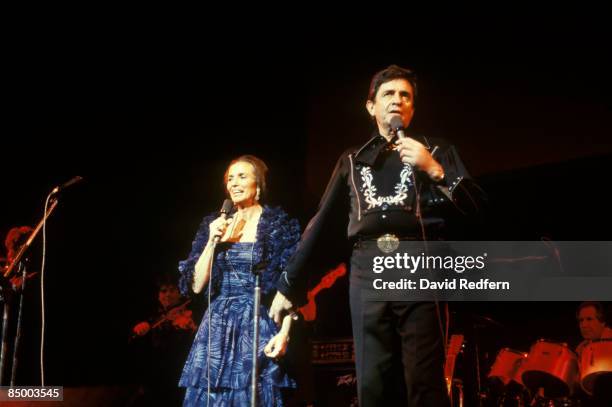 Photo of CARTER FAMILY and June CARTER and Johnny CASH, Johnny Cash performing on stage with wife June Carter Cash