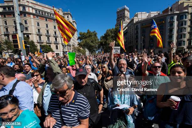 People demonstrate outside the Catalan Vice-President and Economy office as police officers holds a searching operation inside on September 20, 2017...