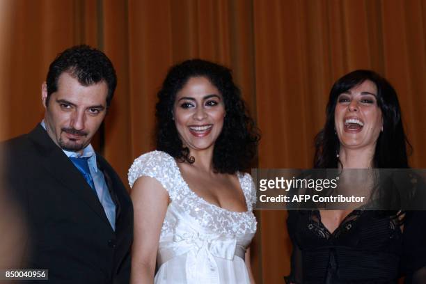 Lebanese film director and actress Nadine Labaki poses for a picture with actors from her film 'Caramel', Adel Karam and Yasmine al-Masri, during a...