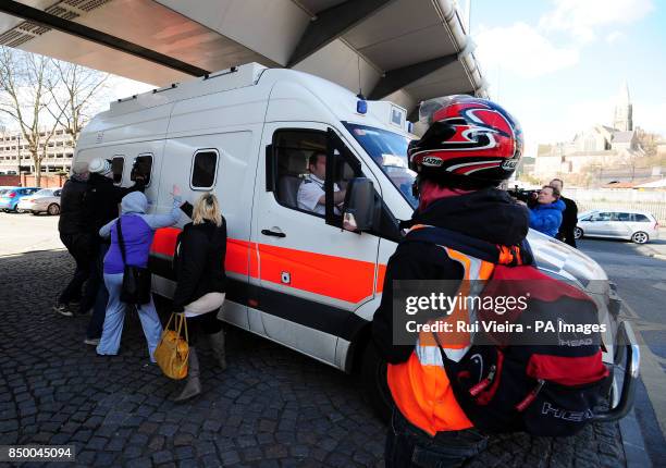 Onlookers reacts to a police van believed to be transporting Mick or Mairead Philpott leaving Nottingham Crown Court.