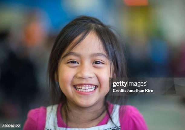 young schoolgirl has a joyous smile. - sonrisa con dientes fotografías e imágenes de stock
