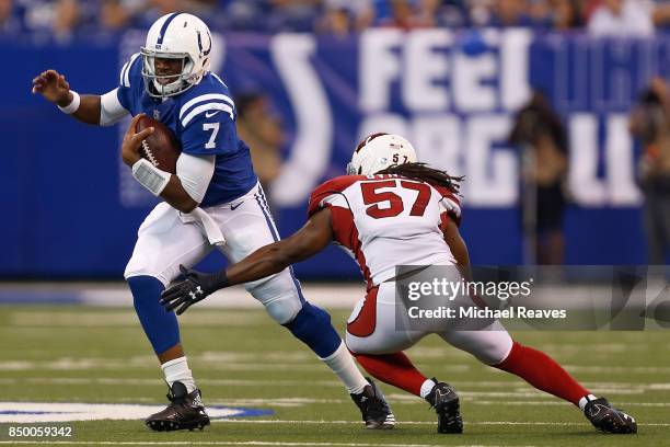 Jacoby Brissett of the Indianapolis Colts breaks a tackle from Josh Bynes of the Arizona Cardinals at Lucas Oil Stadium on September 17, 2017 in...