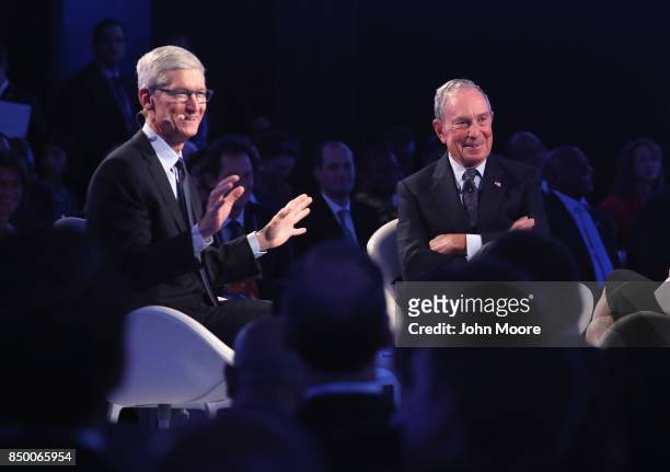 Apple CEO Tim Cook speaks while sitting next to Michael Bloomberg at the Bloomberg Global Business Forum on September 20, 2017 in New York City....