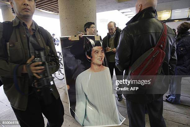 Fan of Edison Chen holds a poster surrounded by media outside the Supreme Court on February 23, 2009 in Vancouver, British Columbia Canada. Edison...