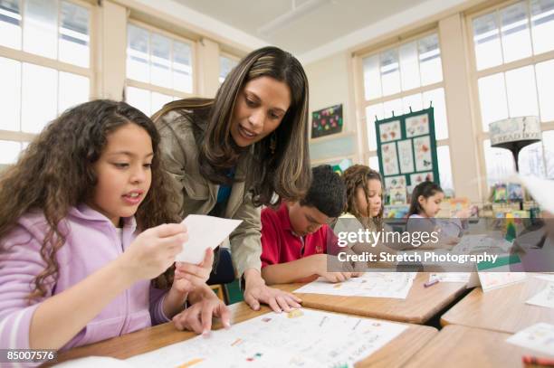 hispanic school teacher helping students - 18-25 2004 stock pictures, royalty-free photos & images