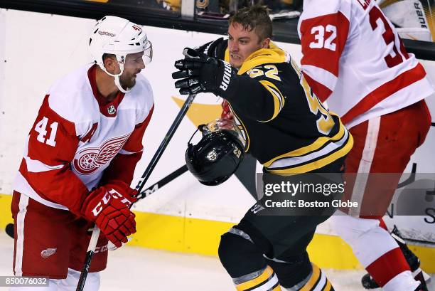 Boston Bruins' Sean Kuraly goes after Detroit's Luke Glendening after slamming into the the Red Wings' Brian Lashoff late in the second period. The...